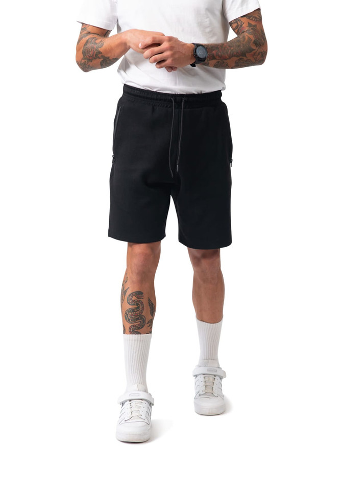 Black cotton dress shorts with an elastic waistband and side pockets, featuring a logo on the leg. Black cotton dress shorts with an elastic waistband and side pockets, featuring a logo on the leg.