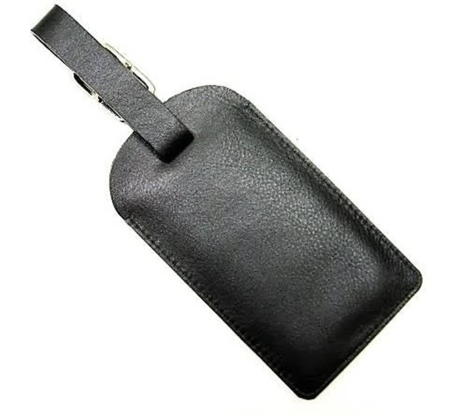 A black luggage tag with a smooth texture and a strap for attachment. It features a silver clip.