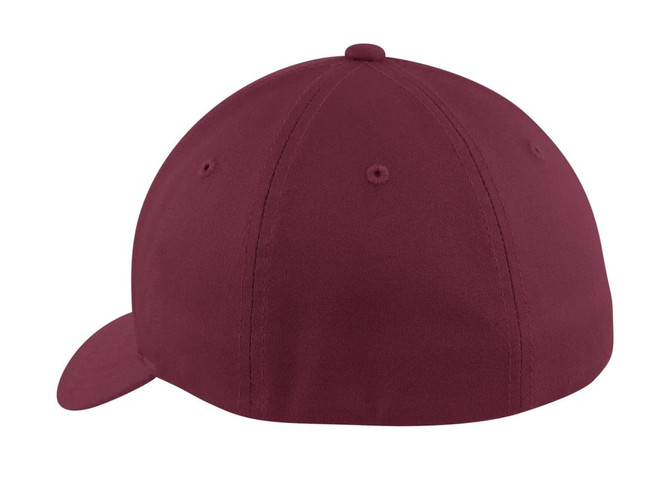 A maroon Flexfit cotton twill cap featuring a rounded design and a branded logo on the side.