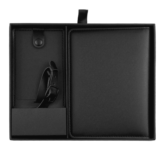 A black travel gift set including a notebook, strap, and cardholder, all in a sleek presentation box with a logo.