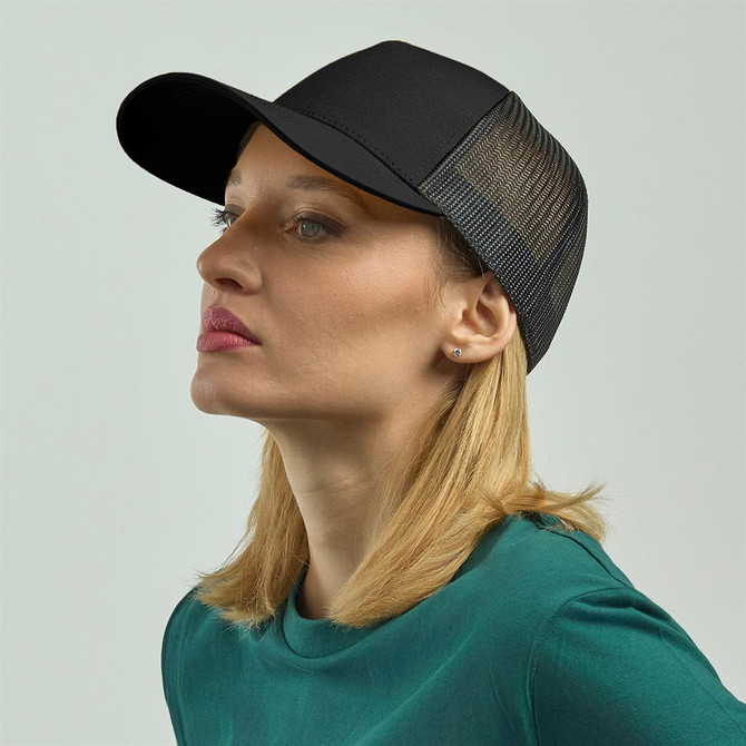 A black trucker cap with a mesh back, displayed on a model with blonde hair and a green top.