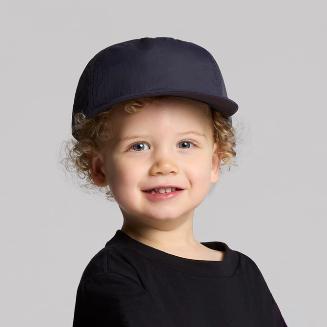 A navy cap for kids with a rounded crown and a stiff peak, featuring a logo on the front.