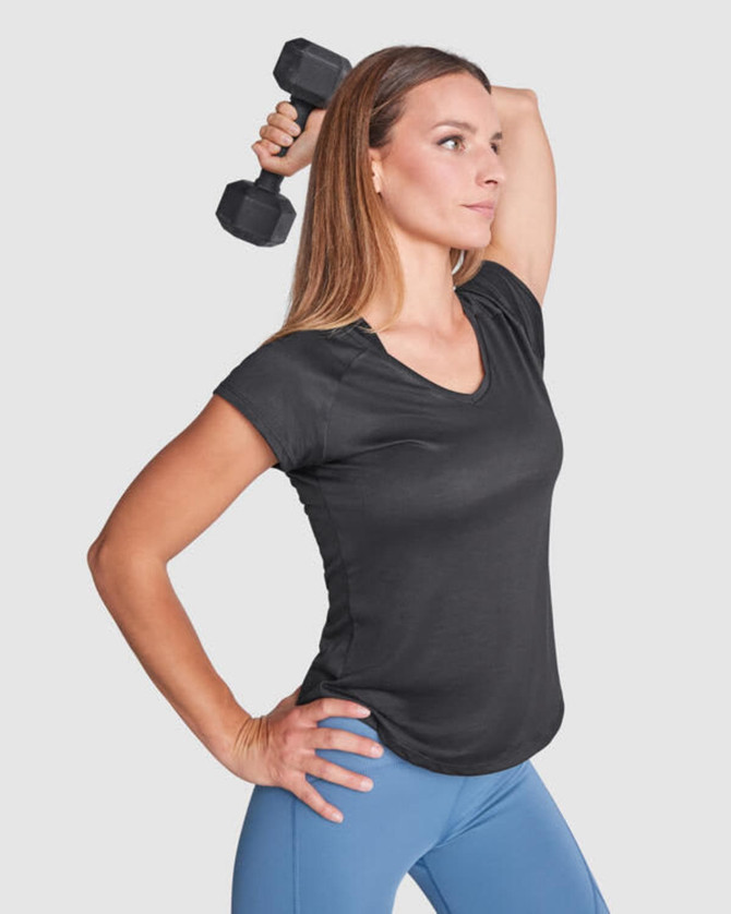 A black women's T-shirt with a V-neck, styled with a model holding a dumbbell, alongside blue leggings.
