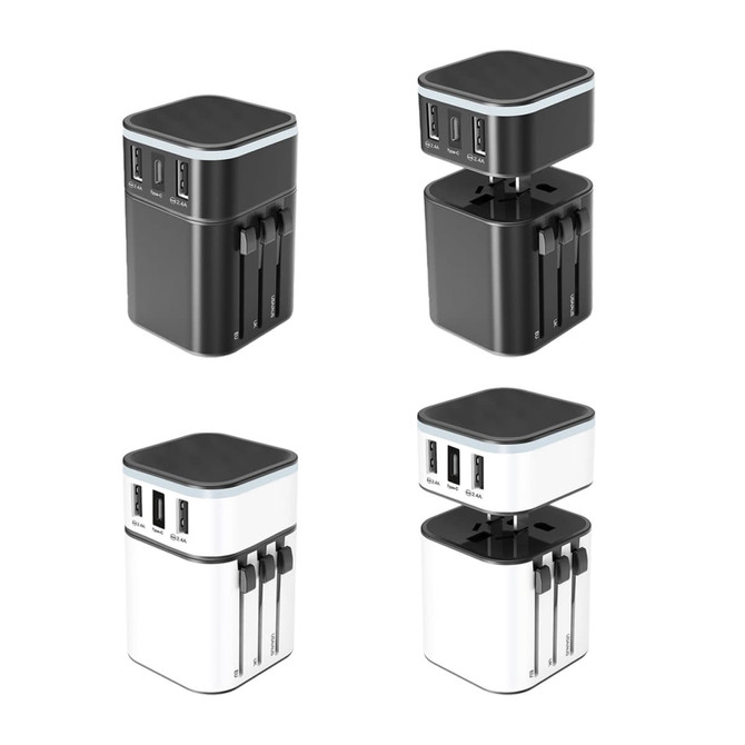 A set of four Luminous Travel Adapters, featuring black and white designs with multiple USB ports and adjustable prongs.