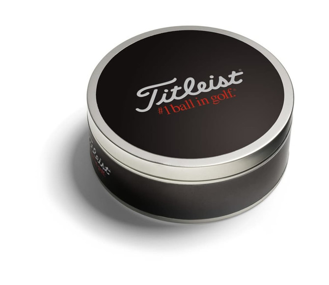 A black tin containing three Titleist golf balls, featuring a branded logo on the lid.