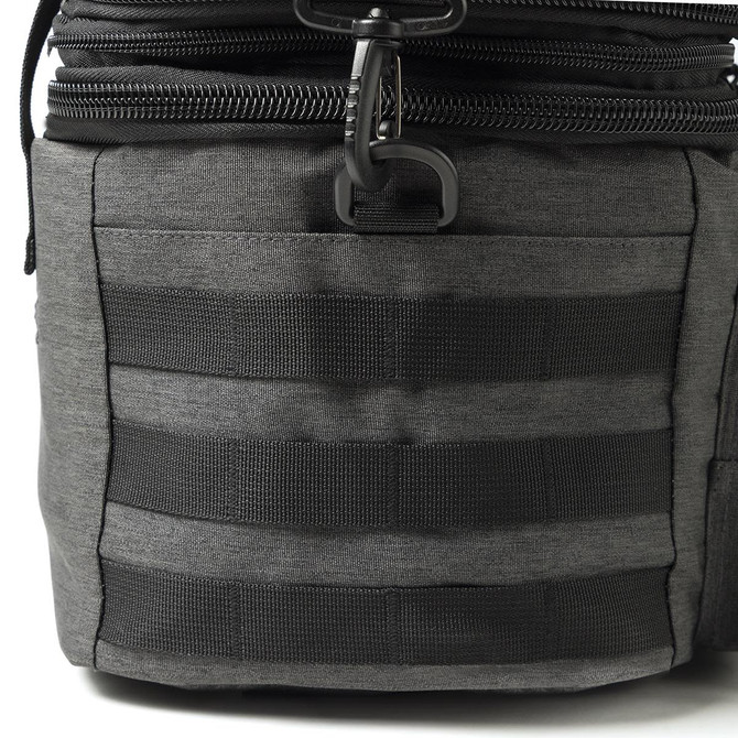 A grey expanding cooler with black webbing and a zipper closure. Features a durable fabric and sturdy construction.