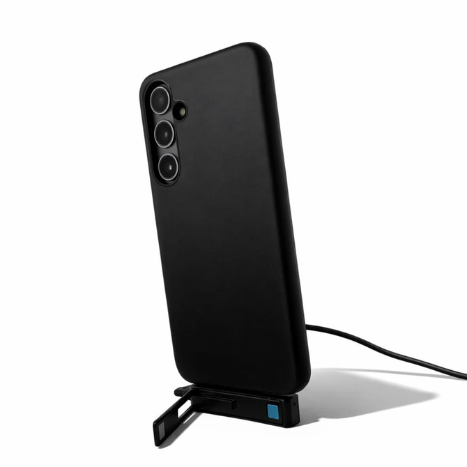 A black phone case with a built-in stand, featuring a charging cable connected to it.