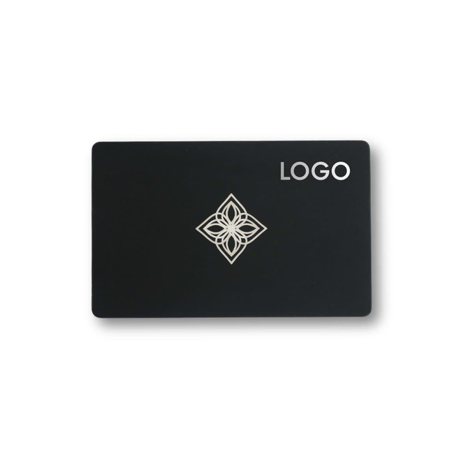 A black card featuring a decorative silver design in the centre and a logo on the top right corner.