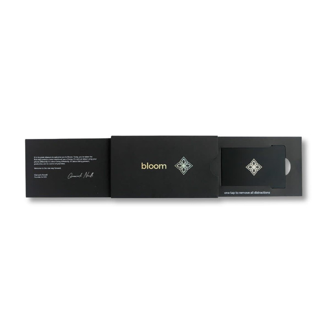 A sleek black presentation box containing a card, featuring a logo and intricate design elements.