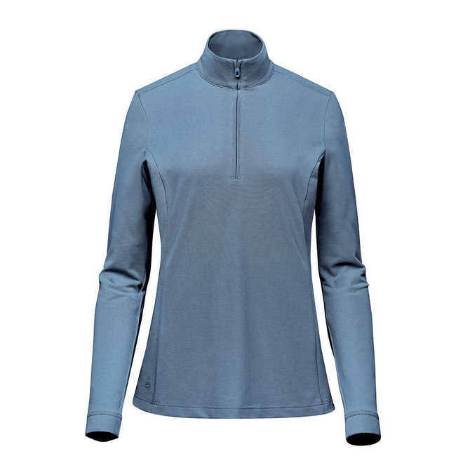 A women's 1/4 zip pullover in a soft blue colour, featuring long sleeves and a stand-up collar. It has a logo.