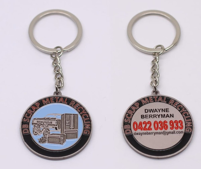 A metal keyring featuring a distinct design, with blue and silver colours, and branding on both sides.