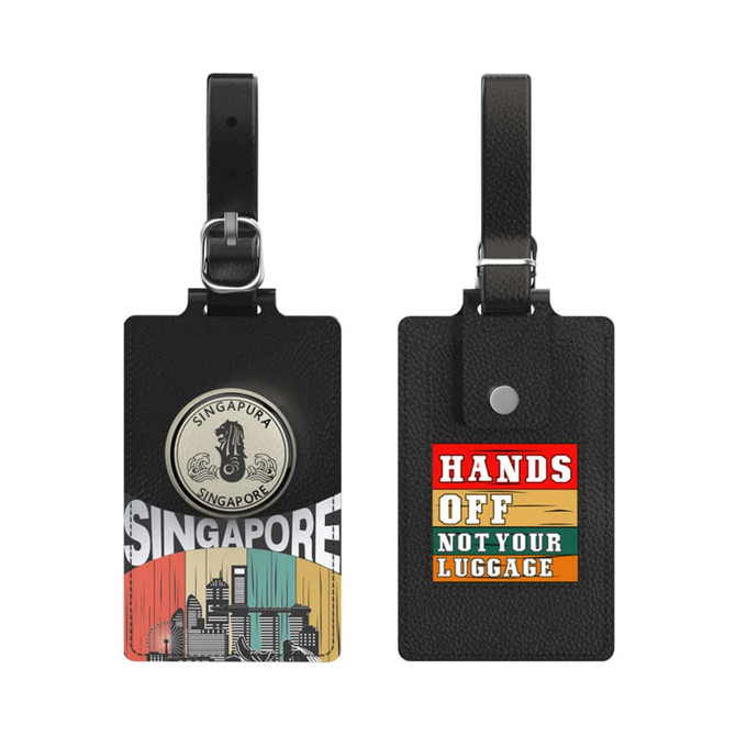 A black luggage tag featuring a circular emblem and a vibrant design with text, showcasing Singapore's skyline and colours.