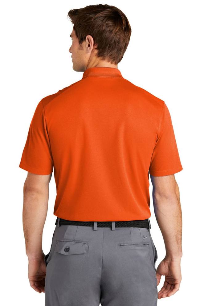 An orange Nike Dri-FIT Micro Pique 2.0 Polo shirt, viewed from the back, featuring a logo on the collar.