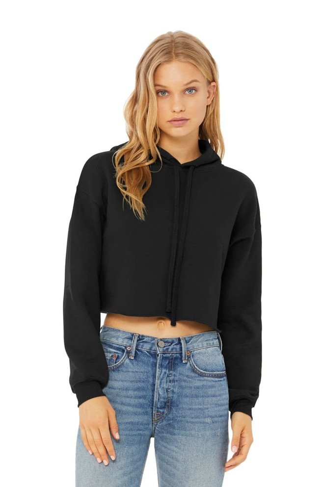 A black cropped fleece hoodie featuring a hood and drawstring, paired with blue jeans. The model poses casually.