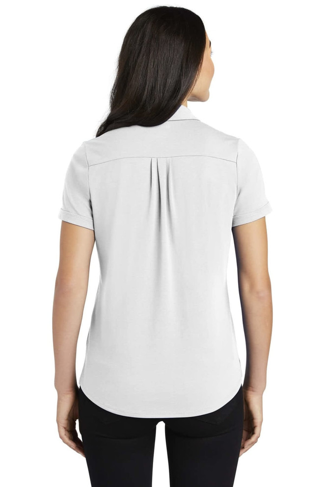 A light grey ladies' polo shirt featuring a back pleat and a collar. The shirt has a branding logo on it.