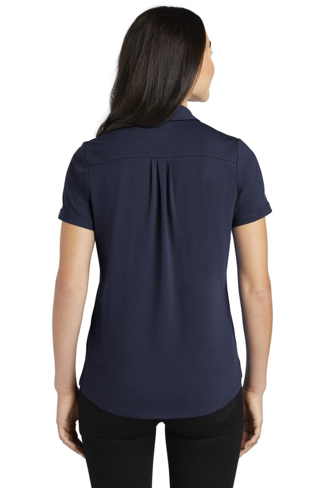 A navy blue ladies' polo shirt with a back pleat and short sleeves, featuring a collar and a logo.