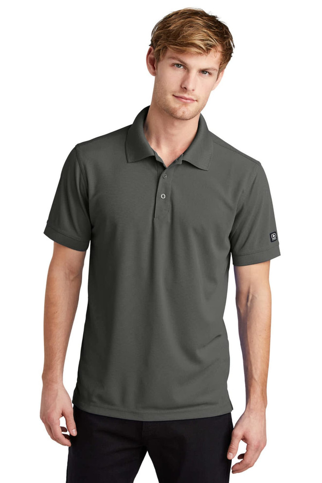 A polo shirt in dark grey, featuring a collar, short sleeves, and a logo on the sleeve.