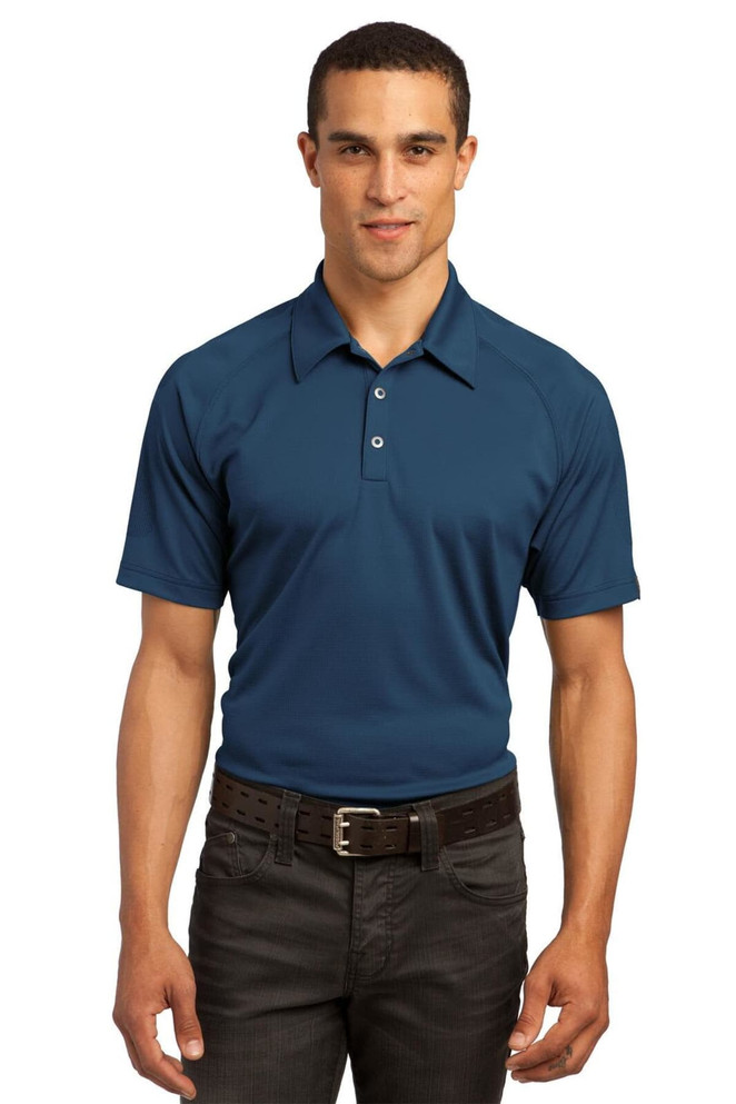 A navy blue polo shirt is displayed on a model, featuring a collar and three-button placket. The shirt has a logo.