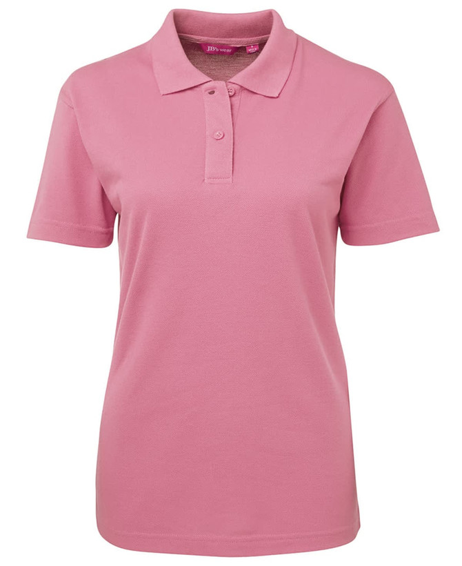 A pink polo shirt for women featuring a collar and buttoned placket, with a logo on the chest.