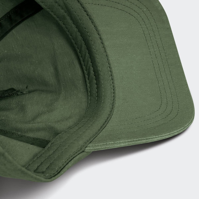 A vintage washed cap in olive green with a structured brim and internal stitching details, featuring a logo.