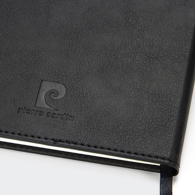 A black diary with a textured cover and a logo embossed on the front. It has a ribbon bookmark.
