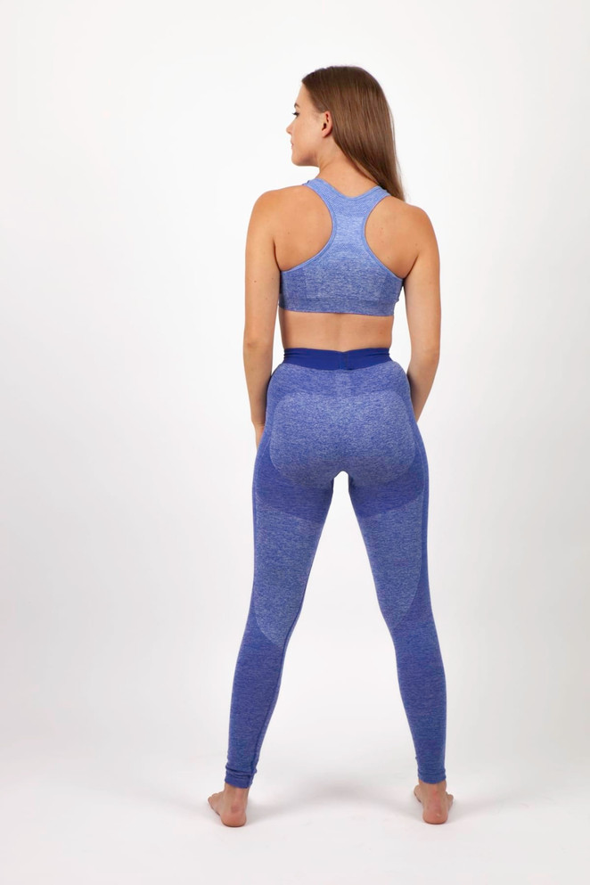 A seamless crop top in blue, paired with matching blue leggings, displayed from the back with a model.