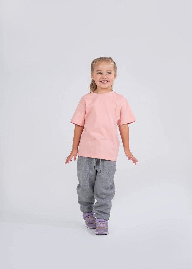 A teal children's t-shirt with short sleeves and a round neckline, featuring a logo on the label.