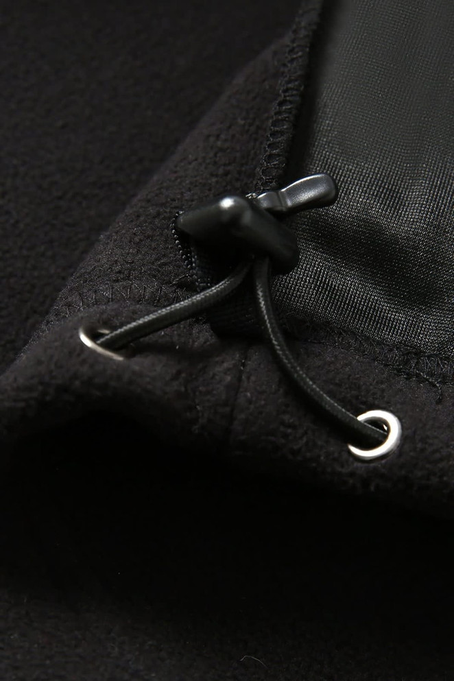 A close-up of a black polar fleece half zip top, featuring a drawstring and fabric detail.