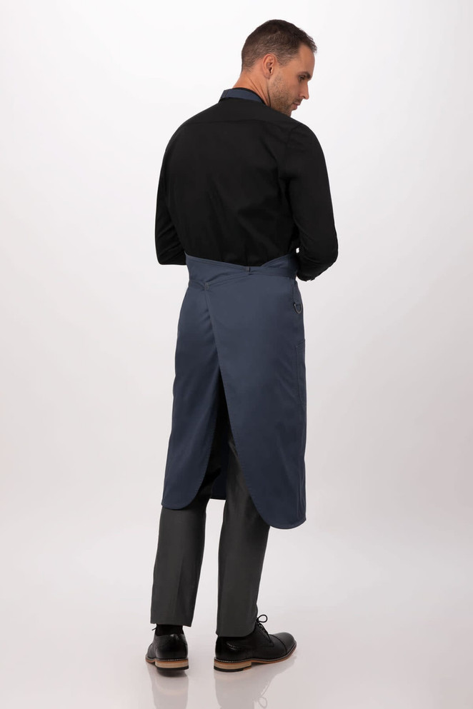 A blue bib apron worn by a person, featuring a back opening and a black long-sleeve shirt.