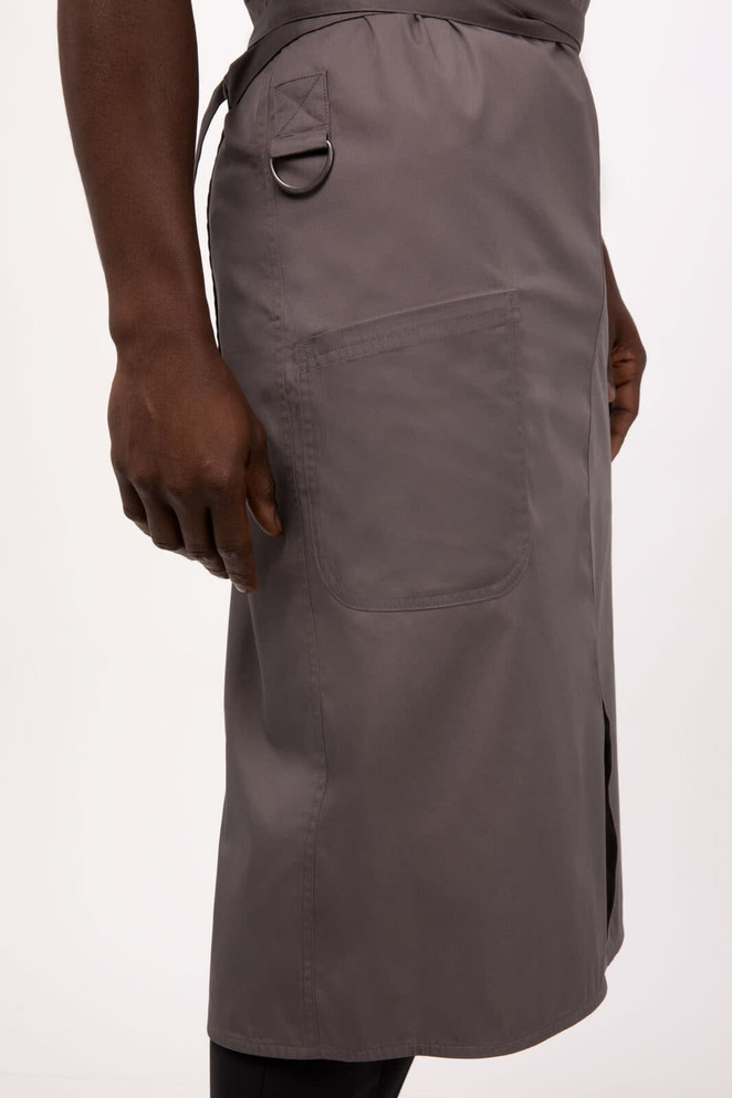 A grey bib apron featuring a pocket and an adjustable waist tie, with a loop for hanging tools.