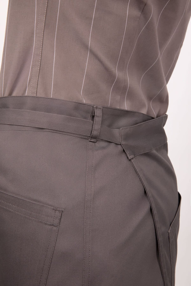 A grey half bistro apron with a side tie and a pocket, featuring a smooth fabric and simple design.