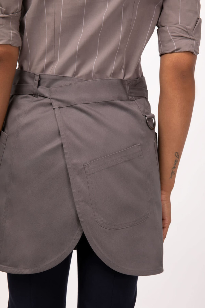 A grey half bistro apron with an adjustable waist and a pocket, featuring a logo on the side.