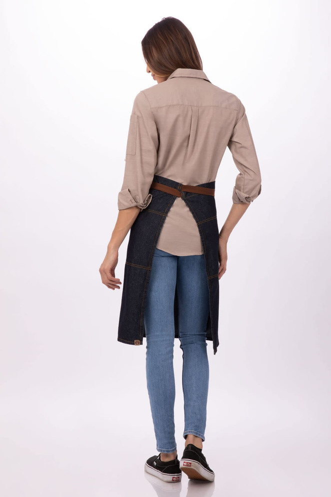 A denim bistro apron with a brown waist tie, worn over a light-coloured shirt and blue jeans, showing a back view.