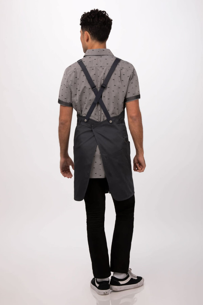 A dark grey Largo Bib Apron worn by a person, featuring adjustable straps at the back.