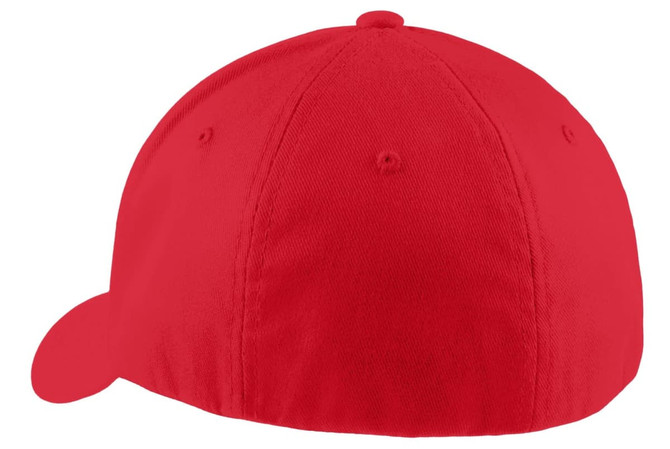 A red Port Authority Flexfit cap featuring a rounded crown and a curved brim, with a logo on the side.