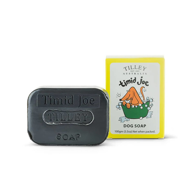 A bar of black dog soap with a yellow box featuring a playful design and a logo. The box is labelled "Timid Joe".