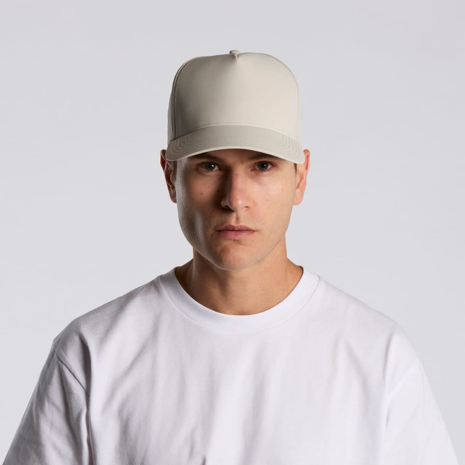 A beige cap made of nylon, featuring a structured design and a logo on the front.