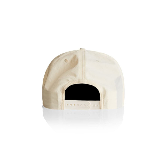 A cream-coloured cap with an adjustable strap at the back and a logo on the side.