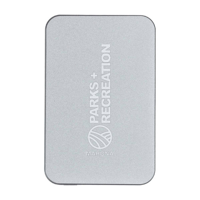 A silver power bank with a minimalist design and a logo. It features rounded corners and a sleek finish.