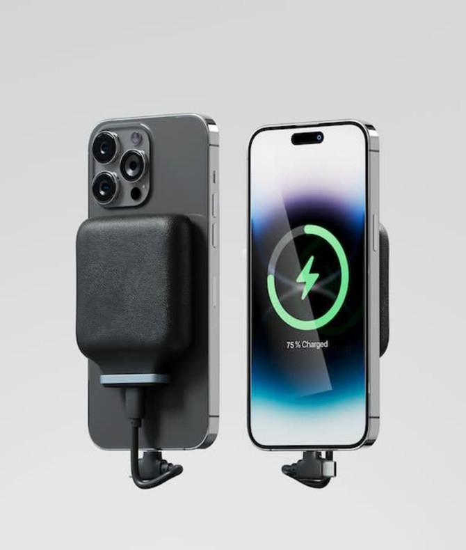 A magnetic wireless power bank in black attached to a smartphone, showcasing its charging feature.