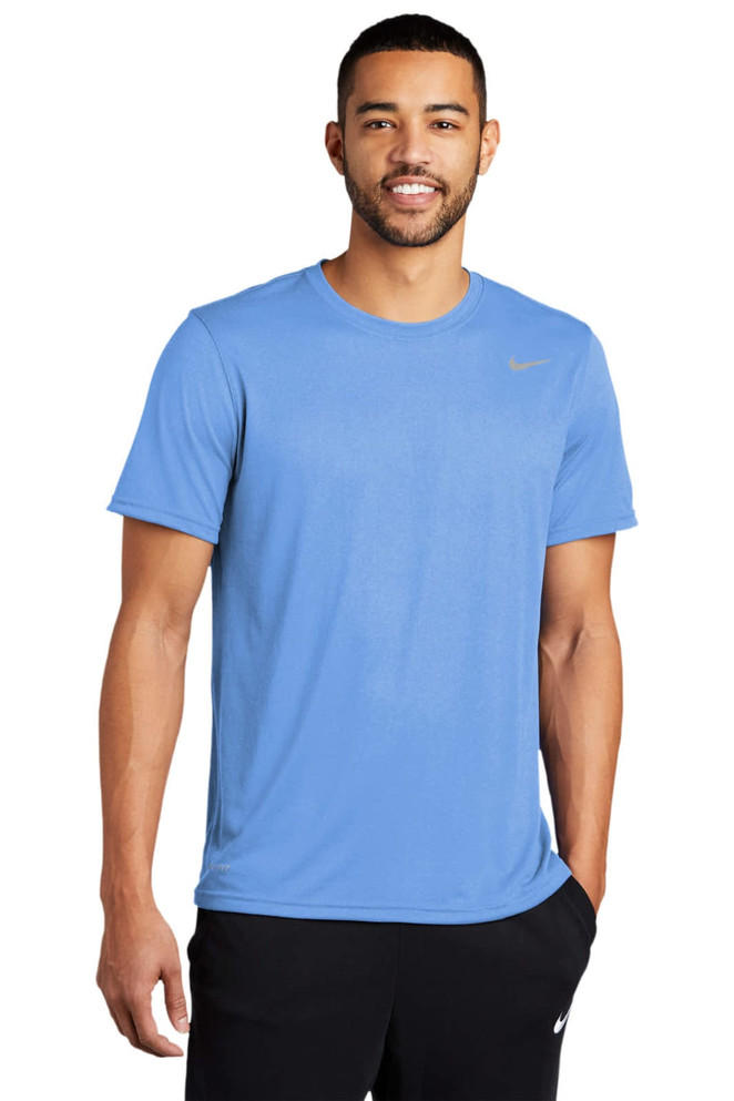 A blue t-shirt featuring a logo, worn by a man with a relaxed posture.