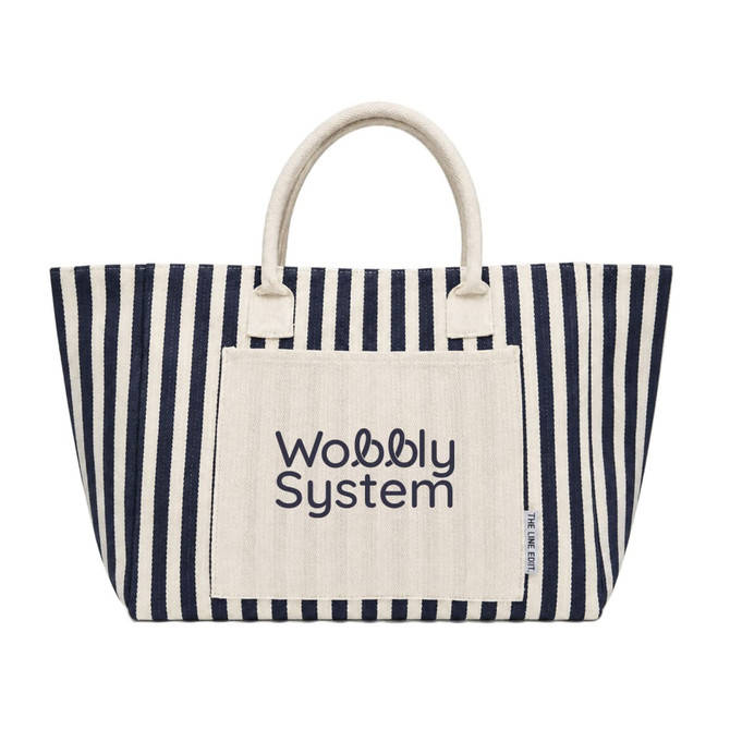 A large striped tote bag in navy and cream, featuring a front pocket with a logo.