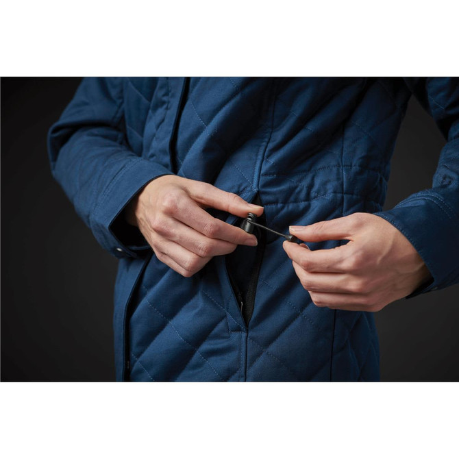 A women's quilted puffer jacket in blue, featuring a zip pocket and adjustable drawstring.
