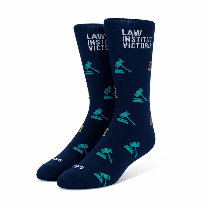 Navy blue socks featuring various gavel and legal-themed illustrations, with a branded logo.
