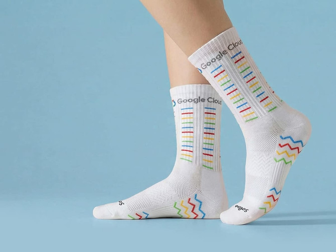 Custom branded cycling socks in white with colourful patterns and a logo, designed for comfort and style.