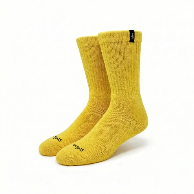 A pair of yellow heavy and thick cotton workwear socks with ribbed texture and a logo.