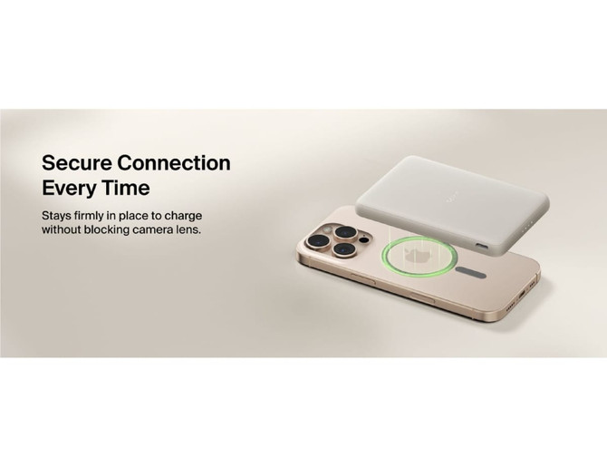 A slim, rectangular power bank in grey magnetically attaches to a smartphone without obstructing the camera lens.
