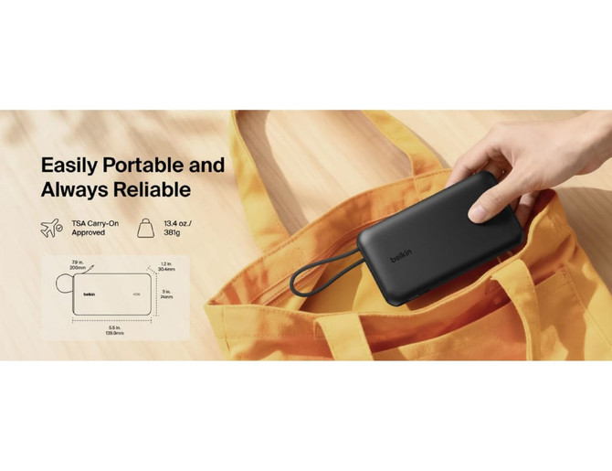 A black power bank is being placed into an orange tote bag, showcasing its portability and compact design.