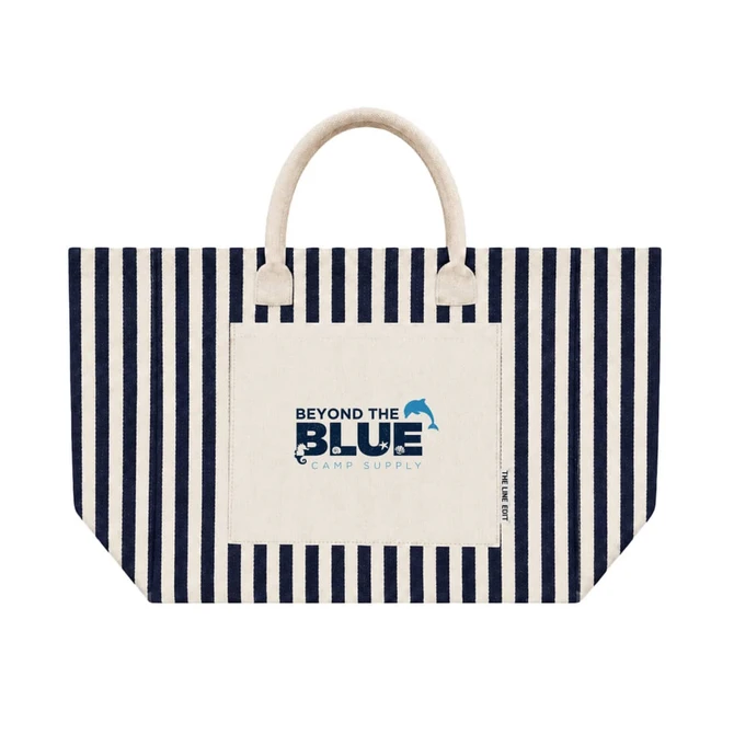 A striped tote bag in navy and cream with a front pocket and a branded logo.