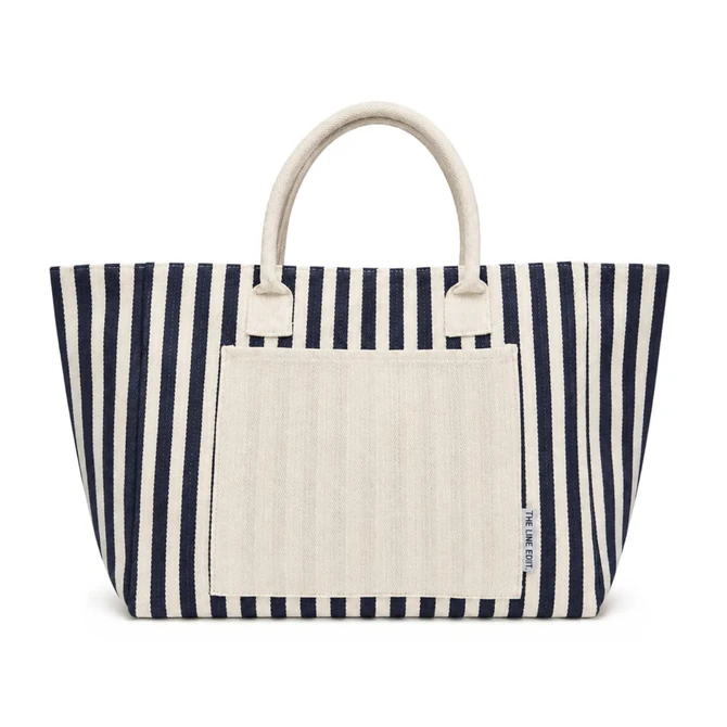 A navy and cream striped tote bag with two sturdy handles and a front pocket. It features a branding logo.